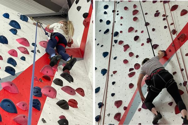 Zwei Personen an der Kletterwand in einer Kletterhalle